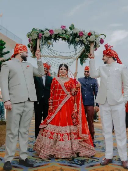 The bride's grand entrance under a beautiful phoolon ki chadar held by her brothers, a traditional and emotional moment we love to document.