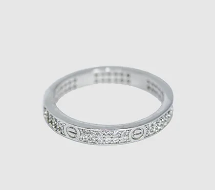An elegant band ring inspired by iconic 'love' motifs, fully studded with American diamonds. This pure 92.5 silver ring is a perfect gift to signify commitment or celebrate an occasion.
