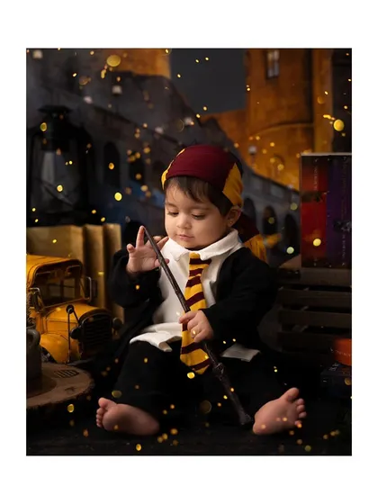 A little wizard casting a spell with golden light effects in this creative Harry Potter setup.