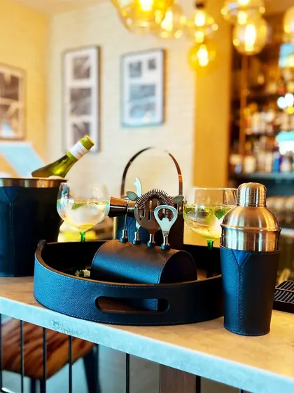 A closer look at our barware in a real-life setting. The rich texture of the leather and the gleam of the metal create a refined and inviting atmosphere at any home bar.