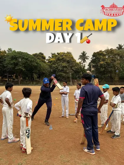 Day 1 of the Summer Camp! A coach demonstrates a batting technique to an eager group of new campers.