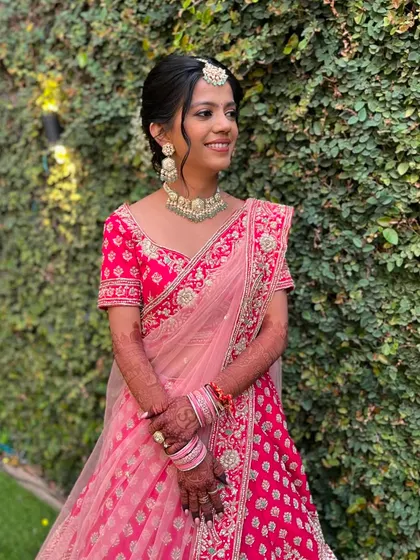 The bride looks radiant and happy. The makeup is designed to be fresh and long-lasting for her destination wedding.