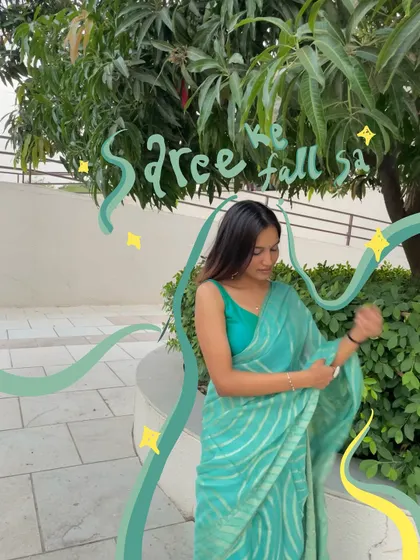 A beautiful turquoise saree moment, with green doodles and sparkles that make it feel like a scene from a movie.