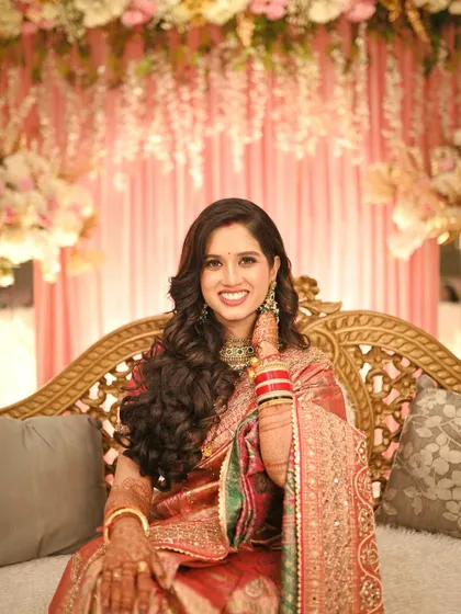 A beautiful, smiling portrait of the bride, looking directly at the camera with confidence and joy.