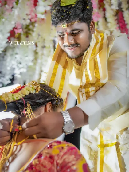 The groom tying the mangalsutra, a deeply significant moment in a Hindu wedding. Our photographers are experienced in capturing these crucial rituals from the best angle.