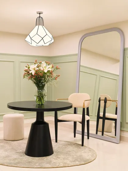 A small, elegant meeting spot in our office. The combination of the sculptural black table, modern chairs, and a large arched mirror creates a sophisticated corner for informal discussions or a quick coffee break.