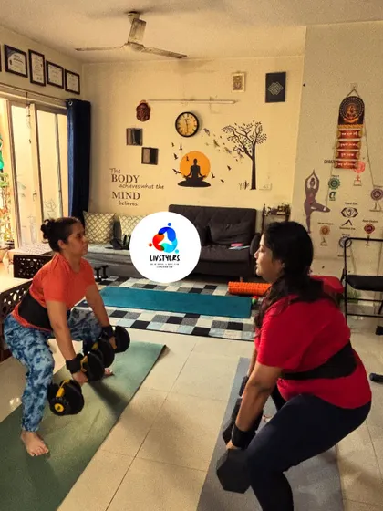Two clients perform sumo squats with dumbbells, a variation that targets the inner thighs and glutes. This is a great exercise for building lower body strength.