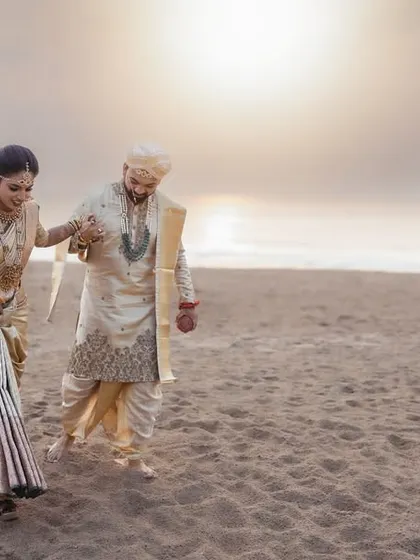 Walking into the sunset on their wedding day. This destination beach wedding photo captures the golden light and the feeling of starting a new journey, hand in hand, on the sands of time.