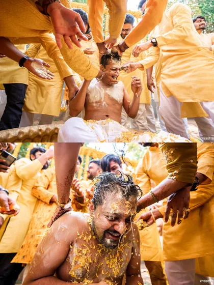 The groom getting completely covered in haldi by his friends. A classic, fun-filled haldi moment.
