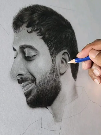 A detail shot using a fine-tipped pencil to add highlights to the groom's ear and beard.
