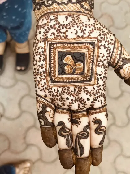 A design featuring dhol drums in the center, perfect for a sangeet party or a music-loving bride. The fingers have simple peacock motifs.
