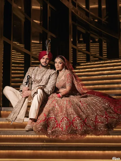 A portrait of regal elegance, where every detail tells a story of heritage and love. This moment from a grand Sikh wedding captures the couple's majestic presence against a backdrop of architectural splendor. My goal is to create timeless portraits that feel like a part of your family's legacy.