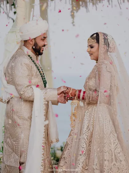 During their seaside Nikah ceremony in Thailand, the bride and groom exchange vows as flower petals rain down. This is the heart of my work: capturing the profound, emotional promises that are made, framed by the beauty of the destination.