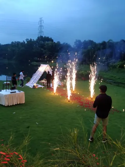 I create magical moments in any setting. This romantic anniversary picnic by the lake, complete with a beautiful tent, fairy lights, and cold pyro fireworks, shows how I can turn an outdoor space into a private, unforgettable experience.