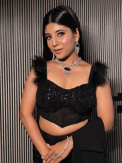 A full portrait of the model in the black lehenga, showcasing its chic and sophisticated vibe. A perfect rental for a formal evening event.