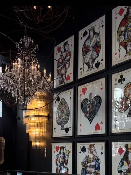 For a truly unique and playful interior, we can create themed gallery walls. This set of oversized, framed playing cards adds a touch of eclectic charm and personality to this luxurious space.