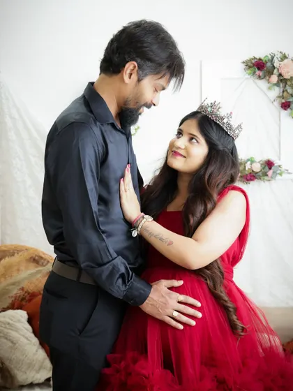 A romantic portrait of an expecting couple. The way they look at each other speaks volumes about their love and excitement.