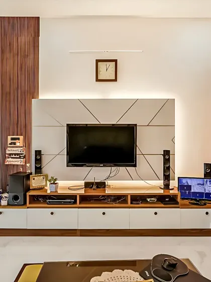 A practical and wide entertainment console designed to accommodate a full home theatre system. The combination of wood and geometric-patterned white panels adds a modern touch, with plenty of storage for media devices.