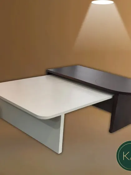 A modern, nesting coffee table with a two-tone finish. The interlocking black and white forms create a versatile and visually interesting centerpiece that can be adapted to different seating arrangements.