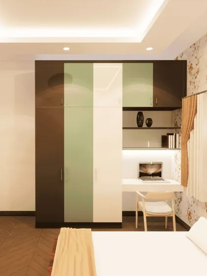 A 3D concept for a bedroom wardrobe that combines dark wood, light green, and white finishes, along with a built-in desk area.