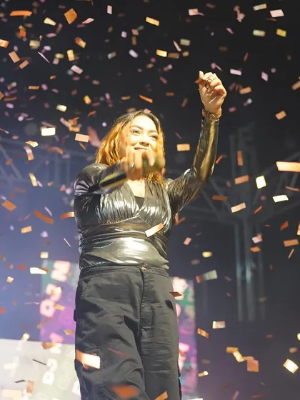 A candid shot of me smiling and enjoying the confetti shower during a grand celebration.
