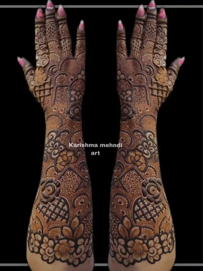 Another example of a heavy Indo-floral design, this mehendi features layers of intricate patterns from the elbow to the fingertips. The symmetrical layout ensures a balanced and cohesive look.