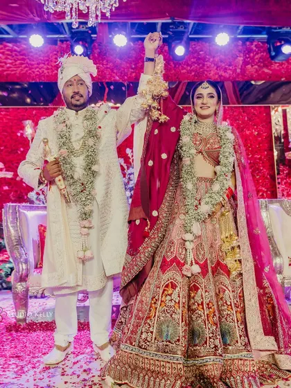 A triumphant moment for the couple after their Varmala, celebrating their union.