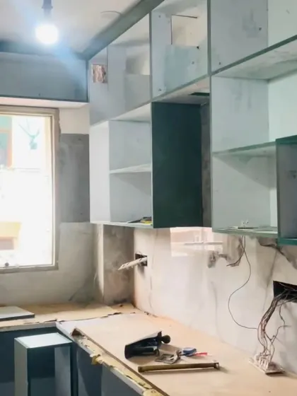 The kitchen during the construction phase, with the basic shelving and electrical wiring in place. This is a crucial step before the final finishes are applied.