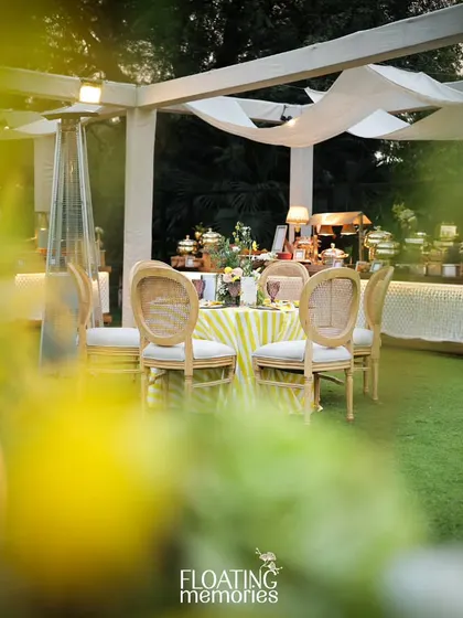 A candid view of the guest seating area, showing the interplay of light and shadow under the draped canopy. The outdoor heaters ensure guest comfort, allowing the celebration to continue seamlessly from day to evening.