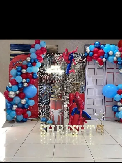 Your friendly neighborhood Spider-Man swings into the party with this action-packed theme. We use city building backdrops, a silver sequin wall, and red and blue balloons to create a superhero adventure.