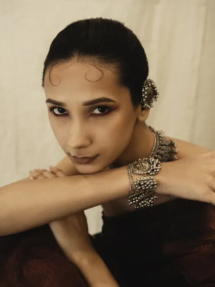 A captivating close-up that highlights the intricate ear cuffs and the model's expressive eyes.