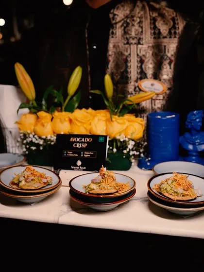 A tray of our "Avocado Crisp" canapés, beautifully arranged and ready to be served. The dish is clearly labelled, a small but important detail in our professional service.