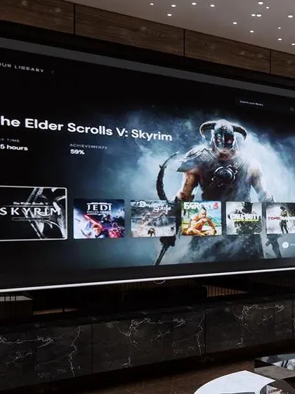 A close-up of the massive projection screen, perfect for gaming or watching movies. The custom black marble console underneath provides stylish storage for all the media equipment.