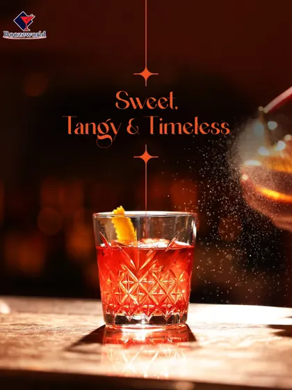 A timeless classic, this Negroni-style cocktail glows with a deep red hue. The orange peel garnish adds a burst of citrus aroma, perfectly complementing the bittersweet flavors of the drink.