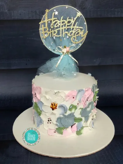 A simple and beautiful cake with a painted floral texture. The custom topper adds a personal touch to this artistic and elegant birthday cake.