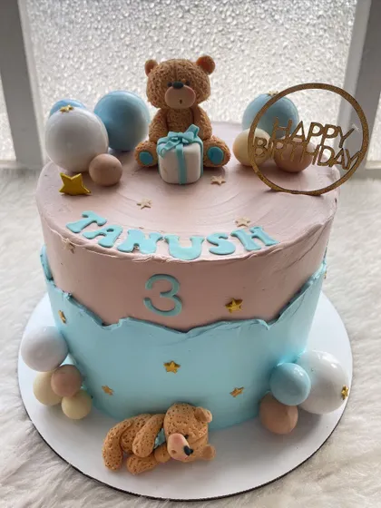 A sweet teddy bear cake for a third birthday. The soft pink and blue colors and cute, sleepy bears make for a very gentle and loving design.