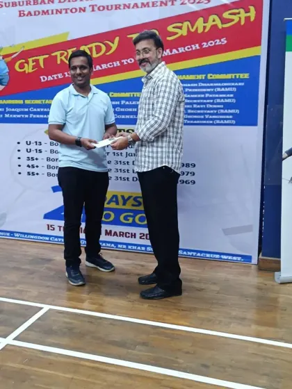 Presenting an award at the WCG Women's Special Badminton Tournament. It is rewarding to recognize the efforts of officials and players.