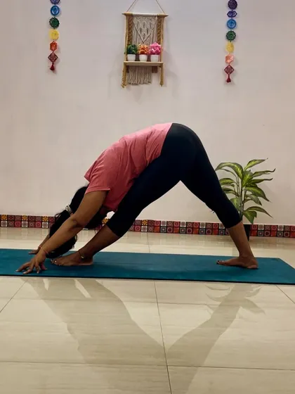 A client practices Parsvottanasana (Pyramid Pose), an intense side stretch that lengthens the hamstrings and spine, and improves balance.