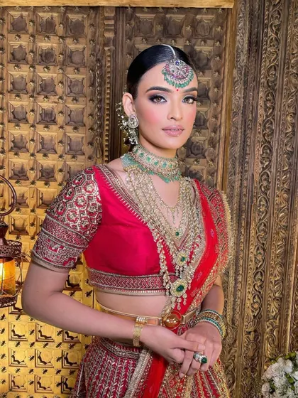 A traditional red bridal look with a sleek, center-parted bun. I teach how to create a clean and polished look that is both timeless and regal.
