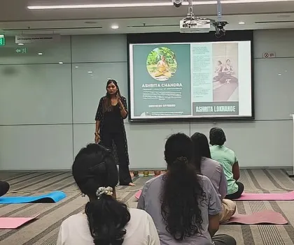 Leading a corporate yoga session at ABB, with my presentation visible in the background. I tailor each session to the specific needs of the team and the company.