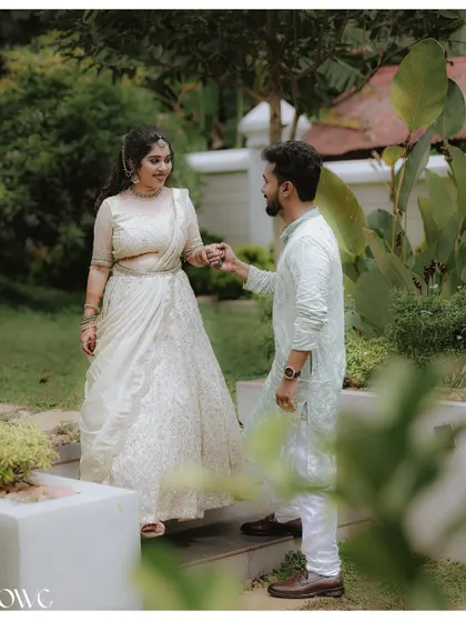 A sweet moment of connection as a couple holds hands on a set of outdoor stairs during their pre-wedding shoot.