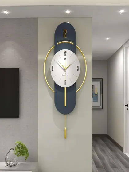 A modern marvel, this imported pendulum wall clock features a sleek, elongated design in navy and gold. The minimalist white clock face is perfectly balanced within a golden ring, creating a piece of functional art for a contemporary space.