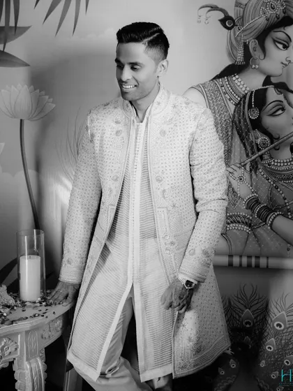 A black and white version of Suryakumar's look, which beautifully highlights the texture and intricate patterns of the Tarun Tahiliani sherwani.