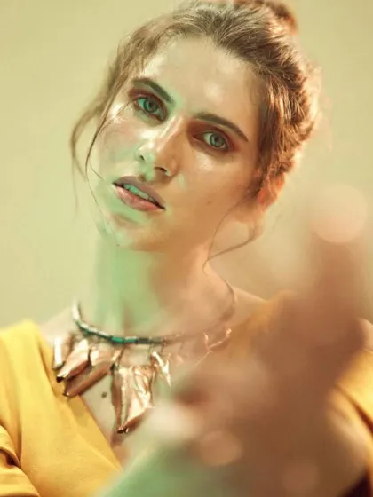An experimental shot from a lighting workshop. I styled the model in a simple yellow top with a statement necklace, allowing the focus to be on how different colored gels and shadows can create a moody and artistic portrait.