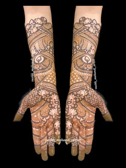 An elegant full-hand design with a focus on flowing, paisley-inspired patterns. The details extend all the way to the elbows.