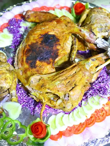 A grand display of our roasted specialities, including a whole mutton and chicken, garnished beautifully for a wedding celebration.