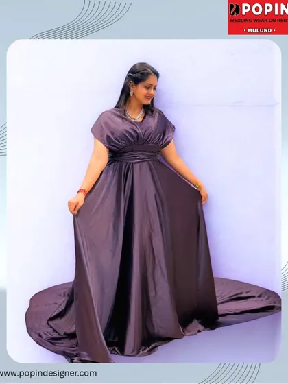 A beautifully edited shot of the purple satin gown, highlighting its silky texture and dramatic trail. This is the definition of red-carpet elegance, available for rent.