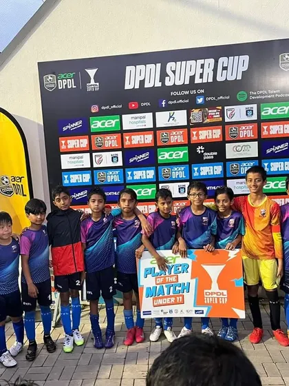 The U11 team with their Player of the Match, staying positive despite a setback.