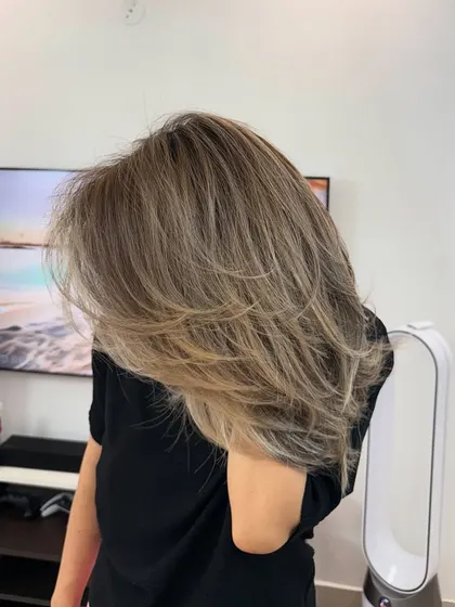 A beautiful, layered cut combined with a soft balayage. The highlights catch the light in the layers, making the hair look full of life and texture.