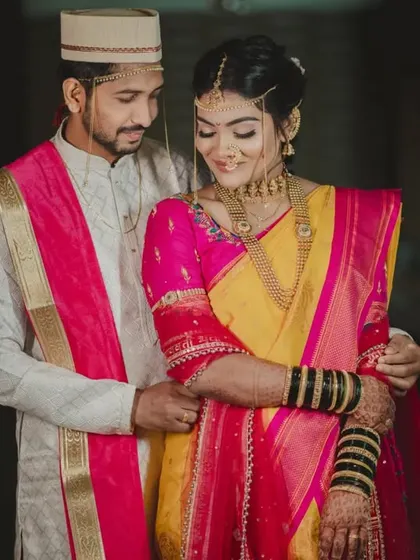 A classic couple portrait showcasing the vibrant colors of their traditional Maharashtrian wedding attire.